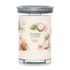 yankee candle with coconuts and flowers on the front, in a glass jar against a white background