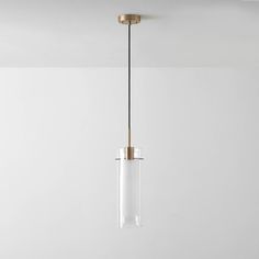 a light fixture hanging from the ceiling in a room with white walls and flooring