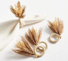 three pieces of dried wheat sitting on top of a white cloth