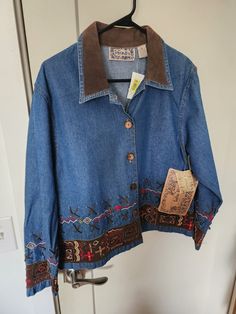 This vintage denim jacket by Tantrums is a stylish addition to any wardrobe. With embroidered leather accents, this jacket is perfect for those who love the classic Western look. The mid-length jacket features a button closure and has long sleeves, making it a versatile piece for both winter and summer. The Aztec and cowboy-themed geometric pattern adds a unique touch to the jacket, and the lightweight and stretchy denim fabric ensures comfort. This jacket is machine washable and easy to care for. It comes in a size small and is suitable for casual occasions. The pockets provide convenient storage for small items. Made in India, this jacket is a must-have for anyone who loves vintage clothes. Denim Jacket Diy Paint, Jacket Diy, Teacher Fits, Upcycled Denim Jacket, Diy Denim Jacket, Embroidered Jean Jacket, Embellished Denim Jacket, Black Men Fashion Swag, Diy Jacket