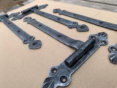 four old style iron door handles and latches laying on top of a cardboard box