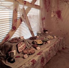 a table topped with lots of food covered in blood