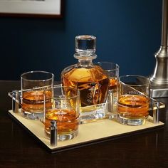 an assortment of whiskeys and glasses on a tray