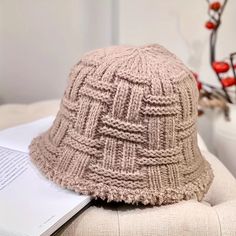 a knitted hat sitting on top of a white chair