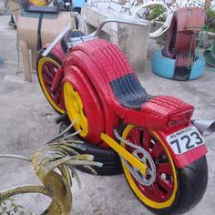 a red and yellow toy motorcycle sitting on the ground