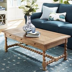 a living room with blue couches and coffee table