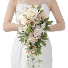 a bride holding a bouquet of flowers in her hand