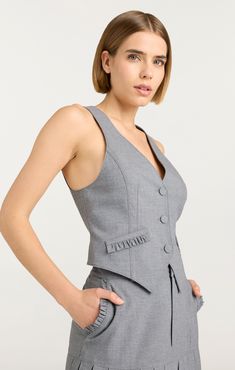 Upgrade your wardrobe with our Bane Vest, featuring a stylish button front, faux pockets, and a flattering v neckline. This sleeveless vest elevates any outfit with its versatile design. Perfect for any occasion, add a touch of sophistication to your look. Details Button frontFabric: Daniela SuitingTailored silhouetteFaux pocket detailsSleeveless length Content and Care 64% Polyester 34% Viscose 2% ElastaneDry CleanImported Measurements 21.5in/54.61cm from shoulderMeasurements from size S Skirt Coverup, Upgrade Your Wardrobe, Short Denim Skirt, Evening Tops, Denim Outerwear, Tank Top Camisole, Steel Grey, Sleeveless Vest, V Neckline