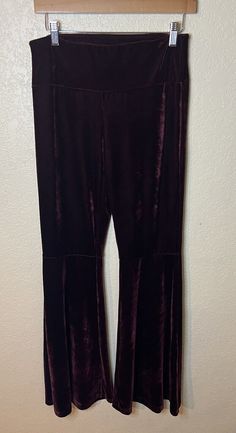 Elevate your wardrobe with these stunning purple velvet pants from Free Spirit. These pants feature a flattering flared leg style, with a comfortable and stretchy polyester and elastane material that ensures a perfect fit. The pull-on closure and flat front design make them easy to wear and pair with any outfit. Machine washable for easy care, these dress pants are perfect for any occasion. The solid pattern and vintage-free design ensure that you'll stand out from the crowd. Available in size medium, these pants are a must-have for any fashion-forward woman's wardrobe. Stretch Velvet Bottoms For Fall, Stretch Velvet Full-length Bottoms, Stretch Velvet Full Length Bottoms, Stretch Velvet Pants For Night Out, Full Length Velvet Stretch Bottoms, Flared Velvet Bottoms, Fall Velvet Flare Bottoms, Purple Wide-leg Pants For Fall, Stretch Velvet Flare Bottoms