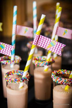 several glasses filled with chocolate milkshakes and sprinkles on top of each other