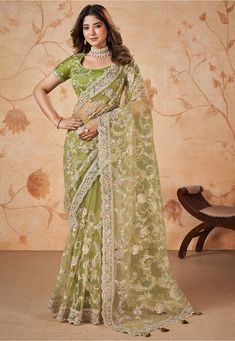 Net Scalloped Saree in Light Green This drape is Enhanced with Resham, Zari and Sequins Work Available with a Semi-stitched Art Silk Blouse in Light Green. Crafted in Round Neck and Short Sleeve Do note: 1.)Accessories shown in the image are for presentation purposes only. 2.)Slight variation in actual color vs. image is possible. Green Net Saree, Cinderella Fashion, Saris Indian, Sequins Saree, Sequins Blouse, Saree Fancy, Sequin Saree, Dress Saree, Bollywood Sarees