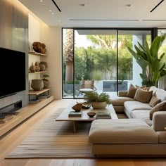 a living room filled with lots of furniture and a flat screen tv mounted on the wall