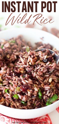 a white bowl filled with wild rice on top of a red and white table cloth