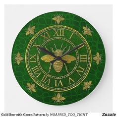 a green clock with gold bees on it