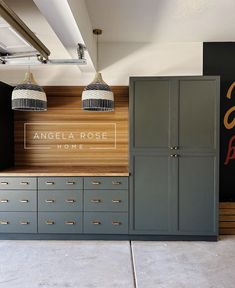 the interior of an office with cabinets and lights on it's walls, along with signs that read angela rose home