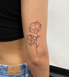 a woman with a flower tattoo on her arm