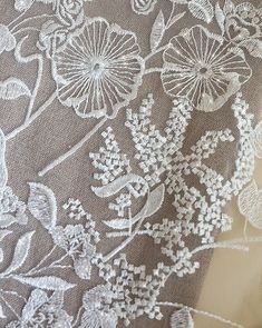 Floral Embroidered Lace Fabric, Wedding Embroidered Cream Fabric With Delicate Lace, White Lace Embroidered Wedding Fabric, Festive White Lace Embroidered Fabric, Cream Lace Fabric With Floral Embroidery, Luxury White Floral Embroidered Lace, White Delicate Lace With Floral Embroidery, Beige Lace Fabric With Floral Embroidery, Beige Lace Fabric With Intricate Embroidery