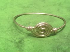 "This beautiful bracelet made based on Viking age archaeological finding. Arm ring made of brass. I currently have 2 bracelets done with diameters approximately: - 3\" (7.5 cm). - 2 5/8\" (6.6 cm). If you need different size, just message me when order. To find out which size will fit you just measure your hand in the widest spot. If you have any questions or would like to have similar bracelet made of different material: copper or silver (for higher price) just message me." Adjustable Medieval Style Bangle Jewelry, Handmade Spiral Metal Bracelet, Medieval Adjustable Bangle Cuff Bracelet, Handmade Viking Style Adjustable Jewelry, Handmade Medieval Metal Bracelets, Adjustable Medieval Style Nickel-free Jewelry, Viking Style Bangle Bracelets, Viking Style Silver Metal Bracelet, Viking Arm Rings