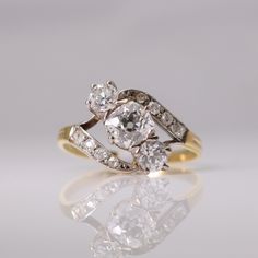 an antique diamond ring with two old cut diamonds