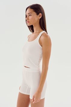 A cropped version of our fabulous Ashby tank. Super soft baby rib fabric hugs your body and layers effortlessly. BEST FOR: running, yoga, CrossFit, barre, Pilates, spin class, cycling and gym workouts. Summer Cropped Activewear For Pilates, Cropped Summer Activewear For Pilates, Cropped Activewear For Pilates In Summer, White Ribbed Sporty Tank Top, Seamless Crop Top Activewear For Summer, Sporty Fitted Tank Top For Yoga, Summer Tank Activewear For Pilates, White Medium Support Crop Top For Spring, White Ribbed High Stretch Tank Top