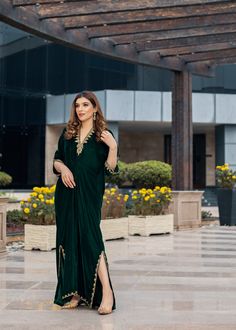 Deep forest green Velvet Kaftan delicately handworked with dabka, nakshi and zardozi on the neckline, shoulder slits, sleeves and front and back hemline and side slits. Kaftan Party Wear, Festive Green Dabka Kaftan, Green V-neck Kaftan For Festive Occasions, Green Kaftan With Resham Embroidery For Festive Season, Green Kaftan With Resham Embroidery For Festive Occasions, Festive Green Kaftan With Resham Embroidery, Green Festive Kaftan With Resham Embroidery, Green Bollywood Kaftan With Dabka Work, Green Kaftan With Dupatta For Party