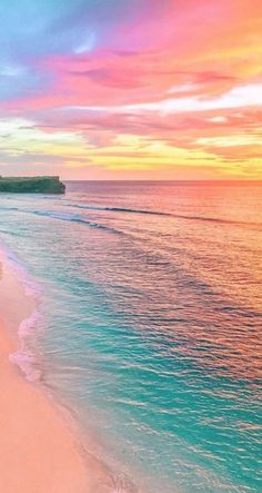 the beach is lined with white sand and blue water as the sun sets over the ocean