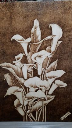 a drawing of some flowers on a brown background