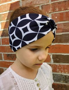 "A practical and cute headband! These bands are great at holding all those pesky little \"fly away\" hairs down, while looking stylish and fun. This headband is cut to be approximately 3.5\" wide and has a diameter of 17\".  Headbands are made with Cotton Lyrca fabric. The material is soft and stretches to fit different head shapes and sizes. Headbands can be worn multiple ways: Put the twist in the back (allowing more coverage to hold hair back in the front), or with the twist in the front for a more narrow and cute look. They can also be worn to cover the ears in cooler weather. Pattern placement will vary. (Care Instructions) Hand wash in cold water and lay flat to air dry. All items are made in my home, and I do have 2 cats in my home." Trendy Elastic Headband, Trendy Adjustable Headband For Gift, Cute Adjustable Headband Headwrap, Cute Adjustable Headband Style Headwrap, Cute Headband Hair Accessory, Cute Adjustable Headwrap Styled As A Headband, Adjustable Black Headband As Gift, Adjustable Black Headband Gift, Black Adjustable Headband