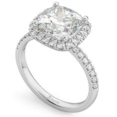 a cushion cut diamond engagement ring with pave set shoulders