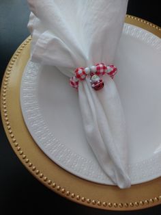 a white plate topped with a red and white napkin