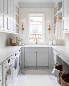 a washer and dryer in a white laundry room