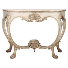 an ornate console table with marble top