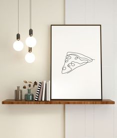 a framed pizza slice sitting on top of a wooden shelf next to a light fixture