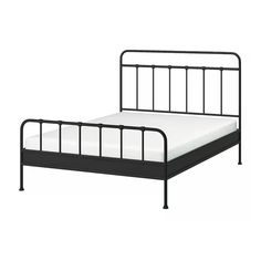 a black metal bed frame with white sheets