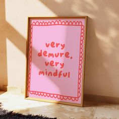 there is a pink sign that says very demure very mindful on the wall