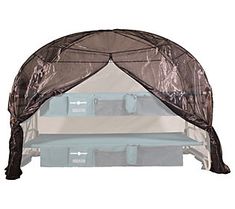 a bed with a canopy over it on top of a white surface and blue drawers underneath