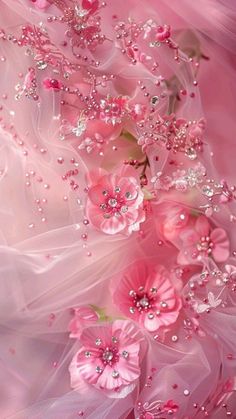 pink flowers and pearls are on the fabric