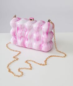 This eye-catching 1970s style handbag features a unique bubble molded design in pretty pink and white hues that will definitely make a statement. The removable chain strap allows for versatile styling options, while the secure snap closure keeps your essentials safe inside.Available while supplies last. Pink Rectangular Clutch With Chain Strap, Trendy Pink Rectangular Clutch, Pink Handheld Clutch With Detachable Strap, Pink Rectangular Clutch With Detachable Strap, Pink Clutch With Chain Strap As Gift, Pink Clutch With Chain Strap For Gift, Pink Clutch With Detachable Strap For Gift, Pink Clutch With Detachable Strap As Gift, 1970s Style