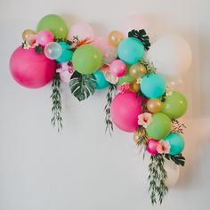 balloons and greenery are hanging on the wall in front of an instagramt for greenweddingshoes