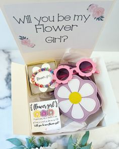 a flower girl gift box with sunglasses and flowers