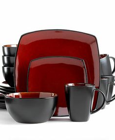 a red and black dinnerware set on a white background