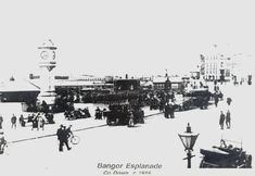 an old black and white photo of people on the street