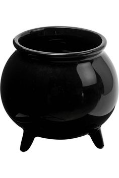 a black pot sitting on top of a wooden stand