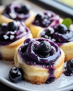 some blueberry donuts are sitting on a plate