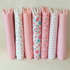 several different colored umbrellas lined up in a row on a table with polka dots