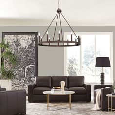 a living room filled with furniture and a chandelier hanging over the top of it