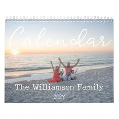 a calendar with three people sitting on the beach