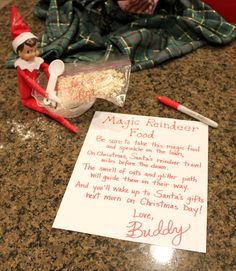 an elf is sitting on the counter next to a note that says, magic reindeer