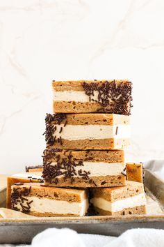 a stack of cake sitting on top of a metal tray