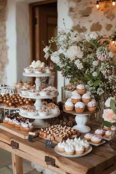 a table topped with lots of cupcakes and cakes